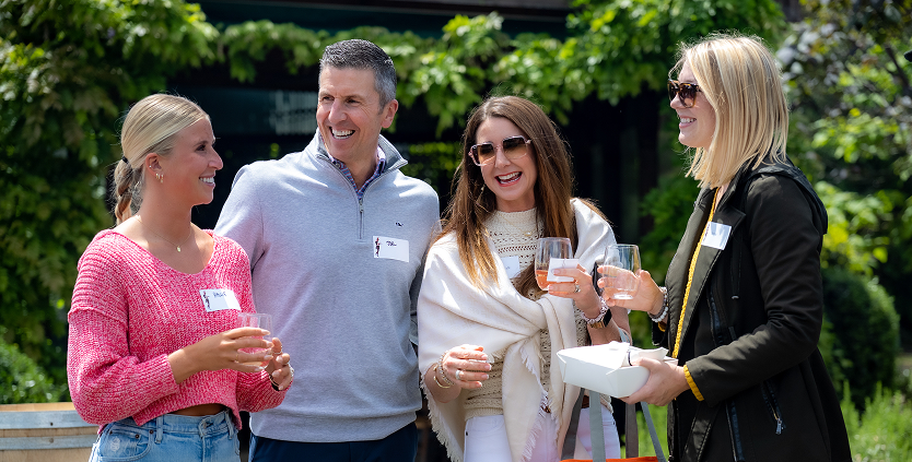 People outdoors sipping wine enjoying their time at Spring Fling