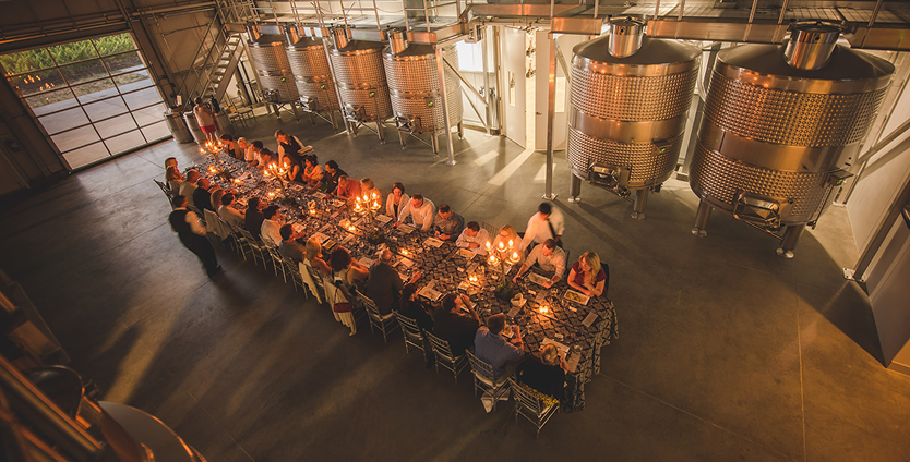 People inside enjoying dinner in the winery